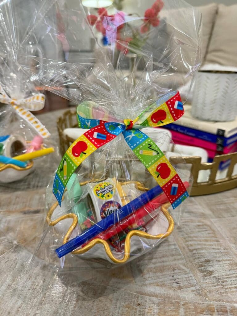 Ceramic bowl filled with teacher goodies, wrapped in a themed bow