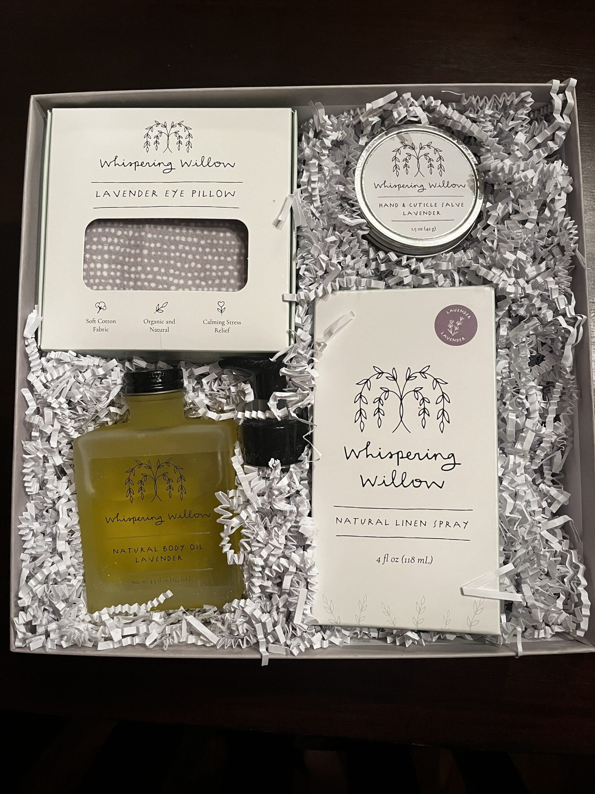 Four products inside Whispering Willow Tranquility Box: Lavender Eye Pillow, Hand & Cuticle Salve, Natural Body Oil, and Natural Linen Spray