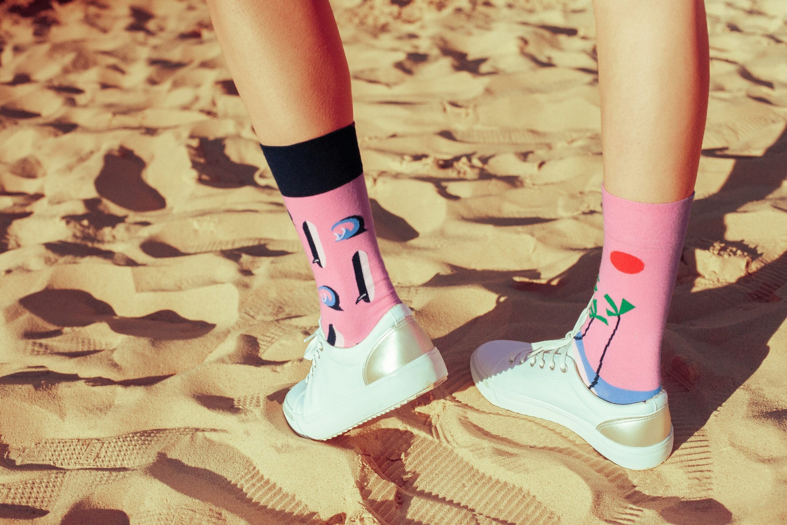 The shins and ankles of a Gen Z woman, with bold, tall socks