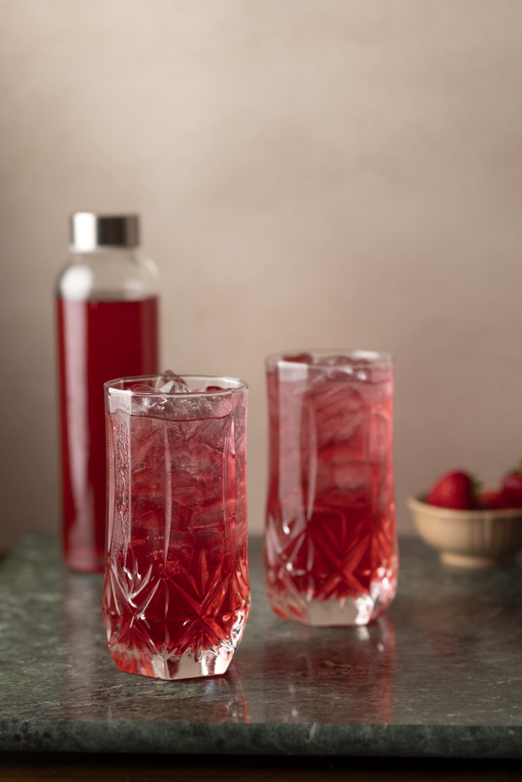homemade strawberry soda in glasses and bottle