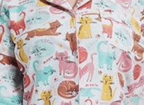 Close up of flannel pajamas with cat illustrations
