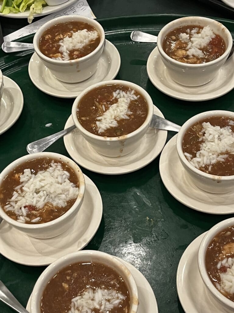 Several bowls of gumbo on a tray