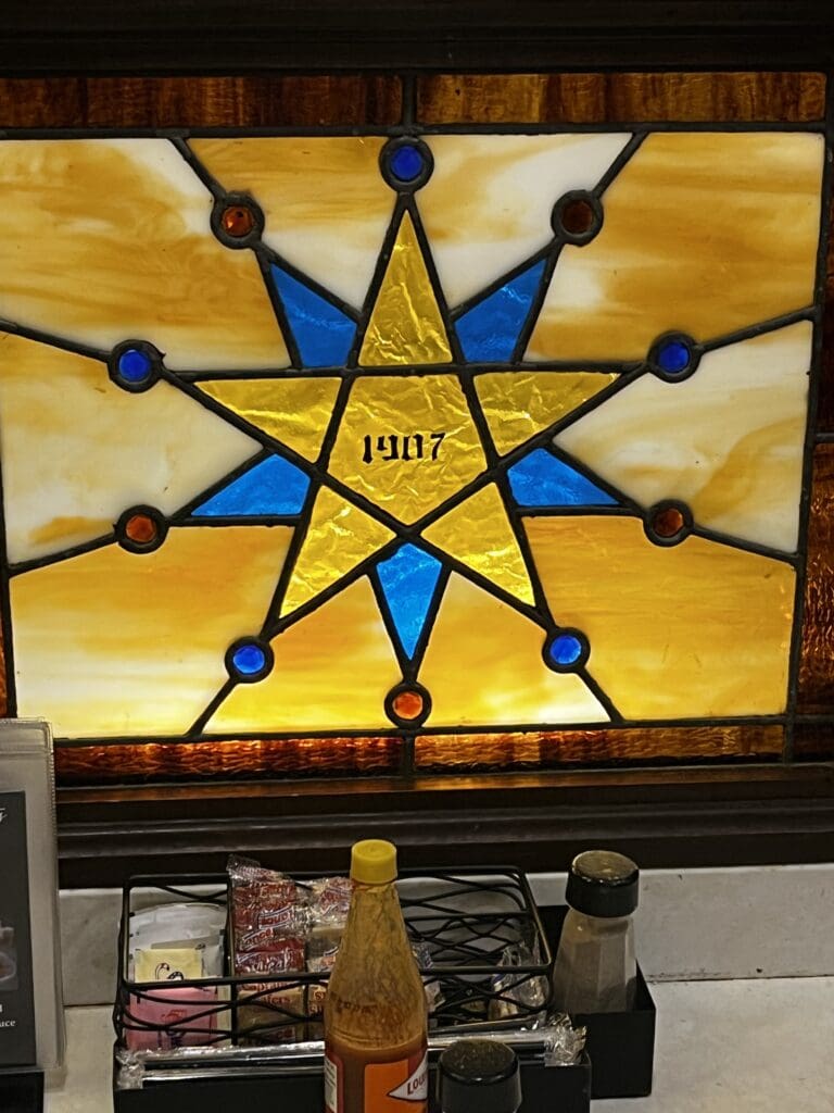 Beautiful stained glass with "1907" in center of star
