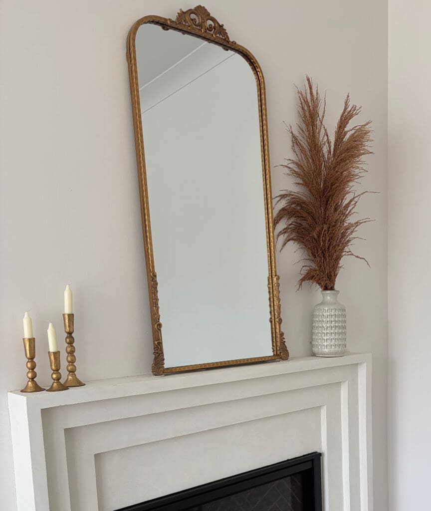 arched mirror over fireplace