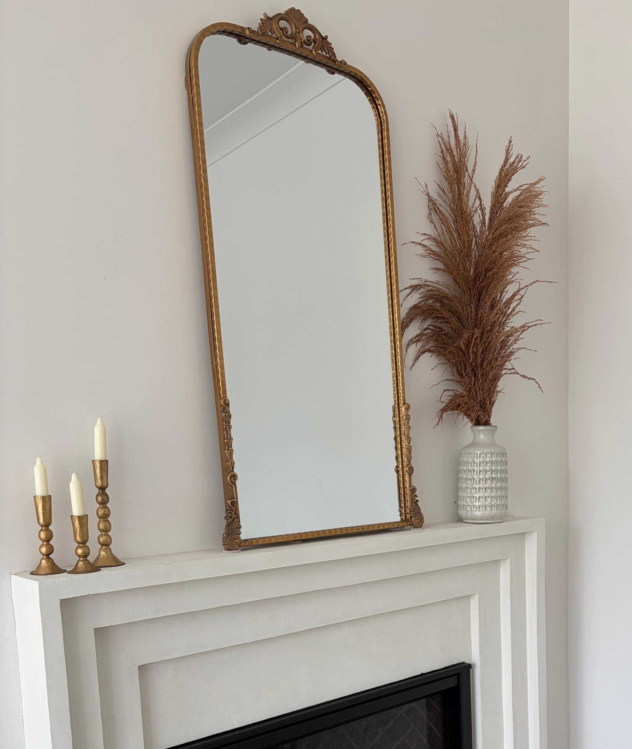 storybook arched mirror over fireplace