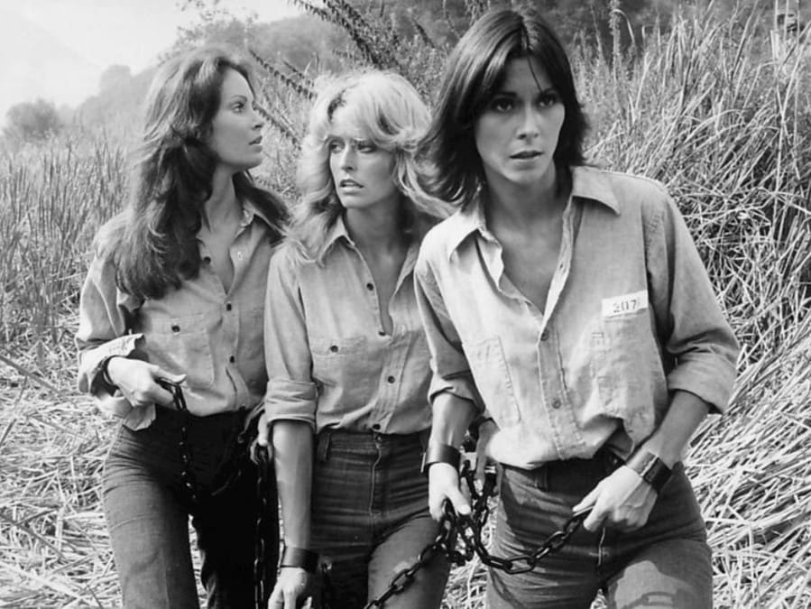 Screenshot of Farrah and the other Angels undercover as female prisoners