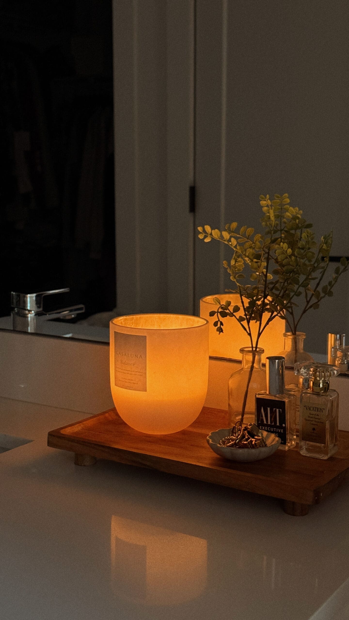 candle burning near perfume